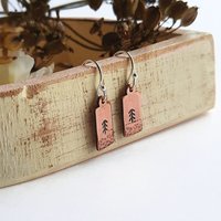 Hand stamped copper pine tree drop earrings, handmade by The Tiny Tree Frog Jewellery