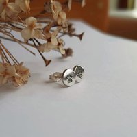 Dainty oxidised sterling silver paw print stud earrings, hand crafted by The Tiny Tree Frog Jewellery