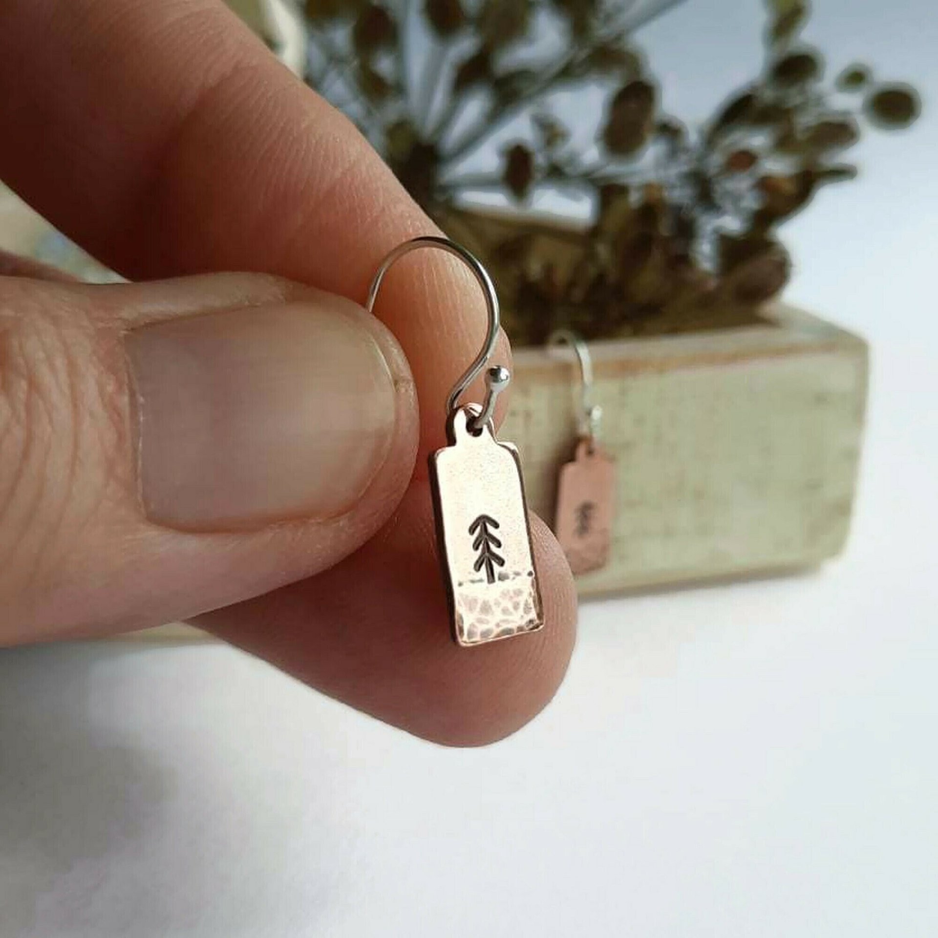 Hand stamped copper pine tree drop earrings, handmade by The Tiny Tree Frog Jewellery