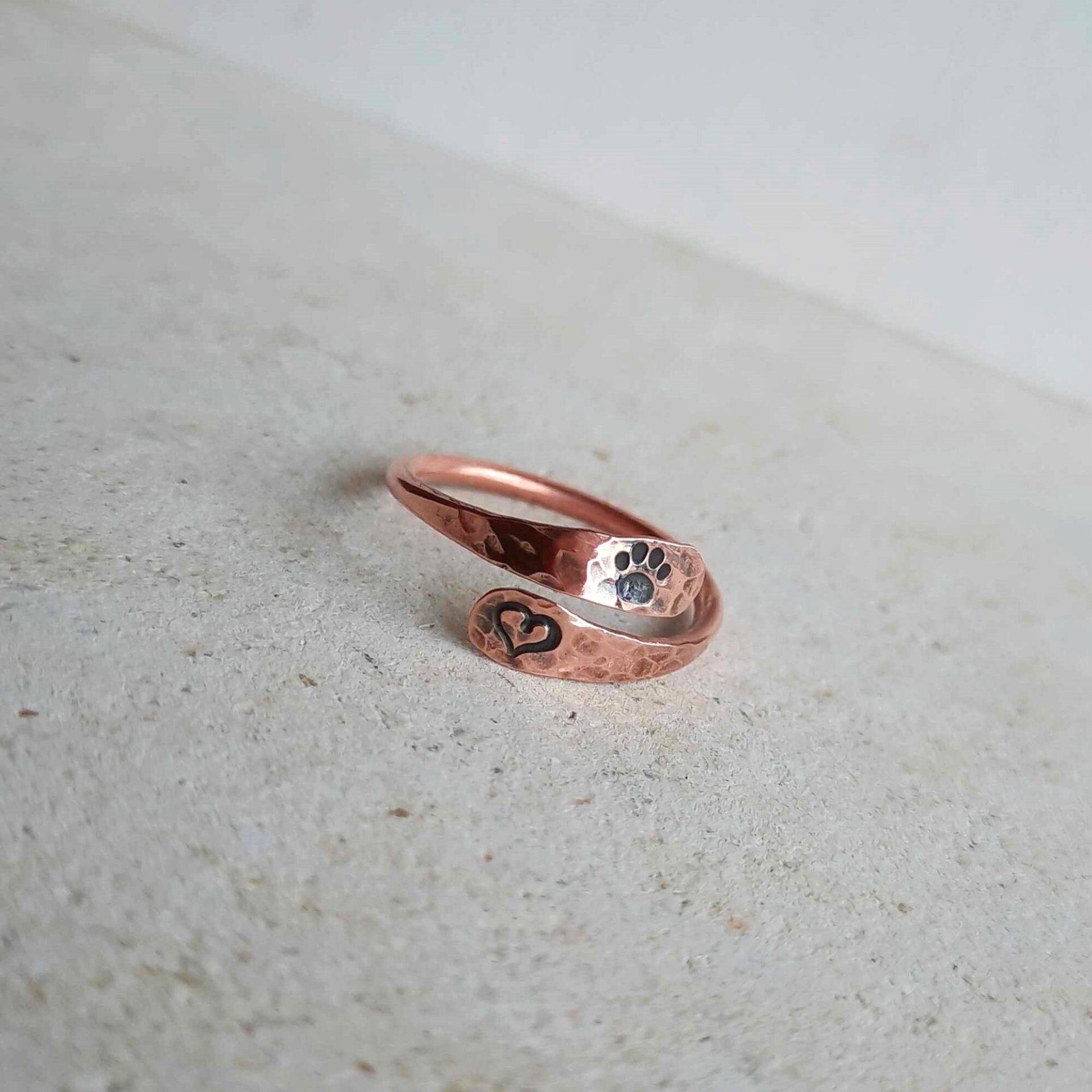 Hammered copper paw print and love heart adjustable crossover ring, hand made by The Tiny Tree Frog Jewellery