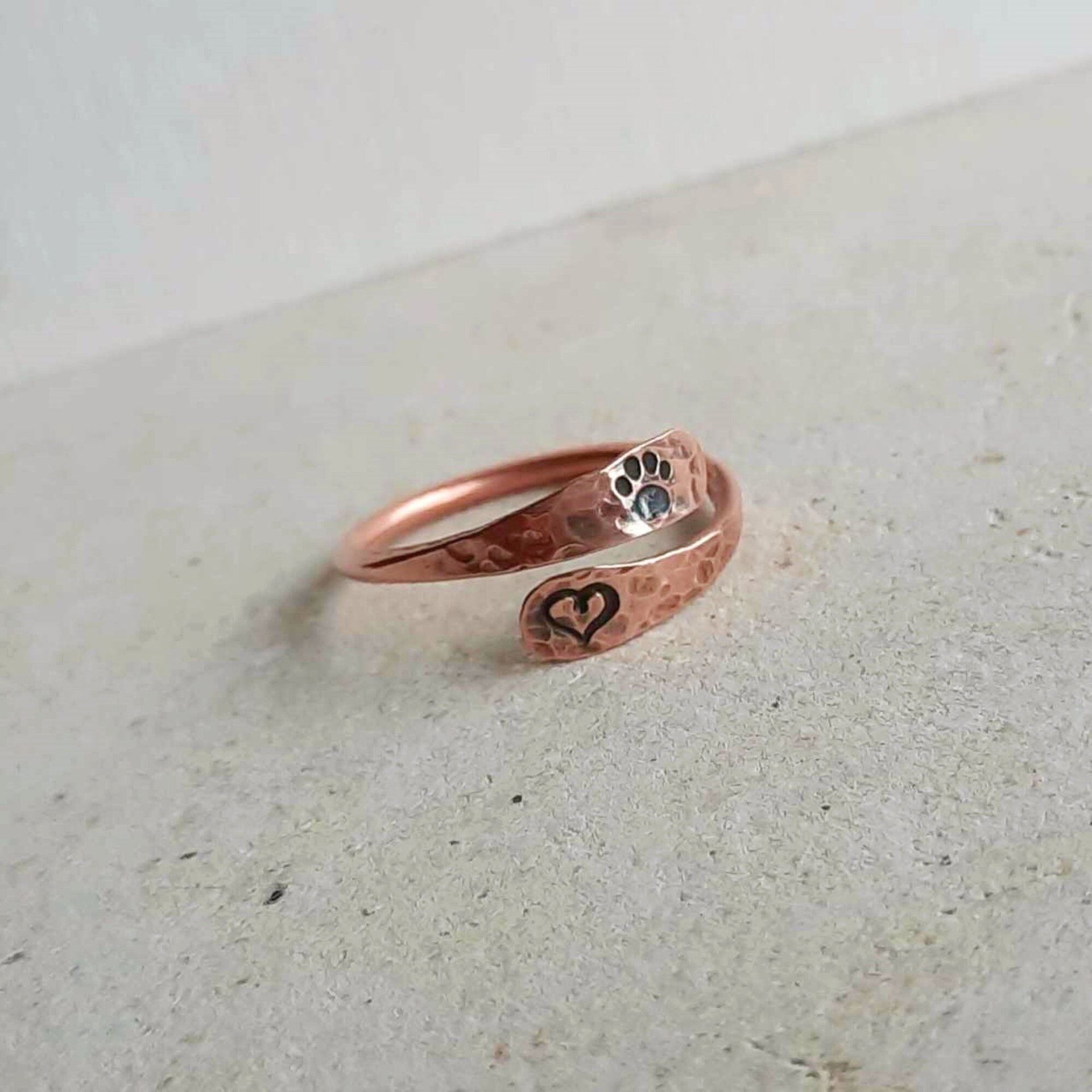 Hand stamped copper paw print and love heart adjustable thumb ring, handcrafted by The Tiny Tree Frog Jewellery