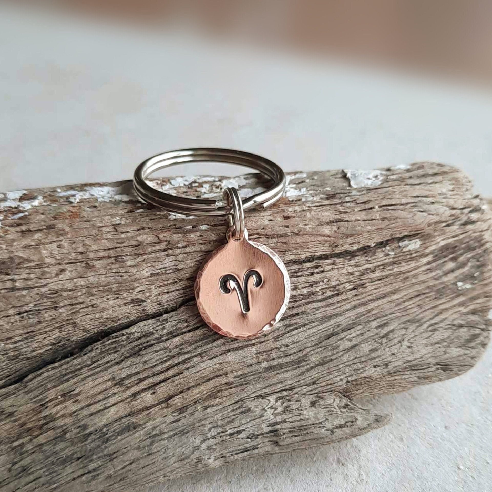 Hand stamped copper Aries zodiac symbol key ring, handmade by The Tiny Tree Frog Jewellery