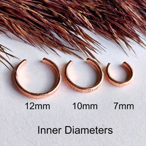 Three copper ear cuffs showing 7mm, 10mm and 12mm inner diameter size options