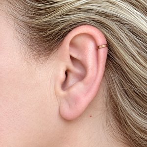 Handcrafted no-piercing copper ear cuff worn around the helix of the ear
