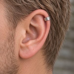 Hammered sterling silver ear cuff shown being worn on the helix of a man's ear