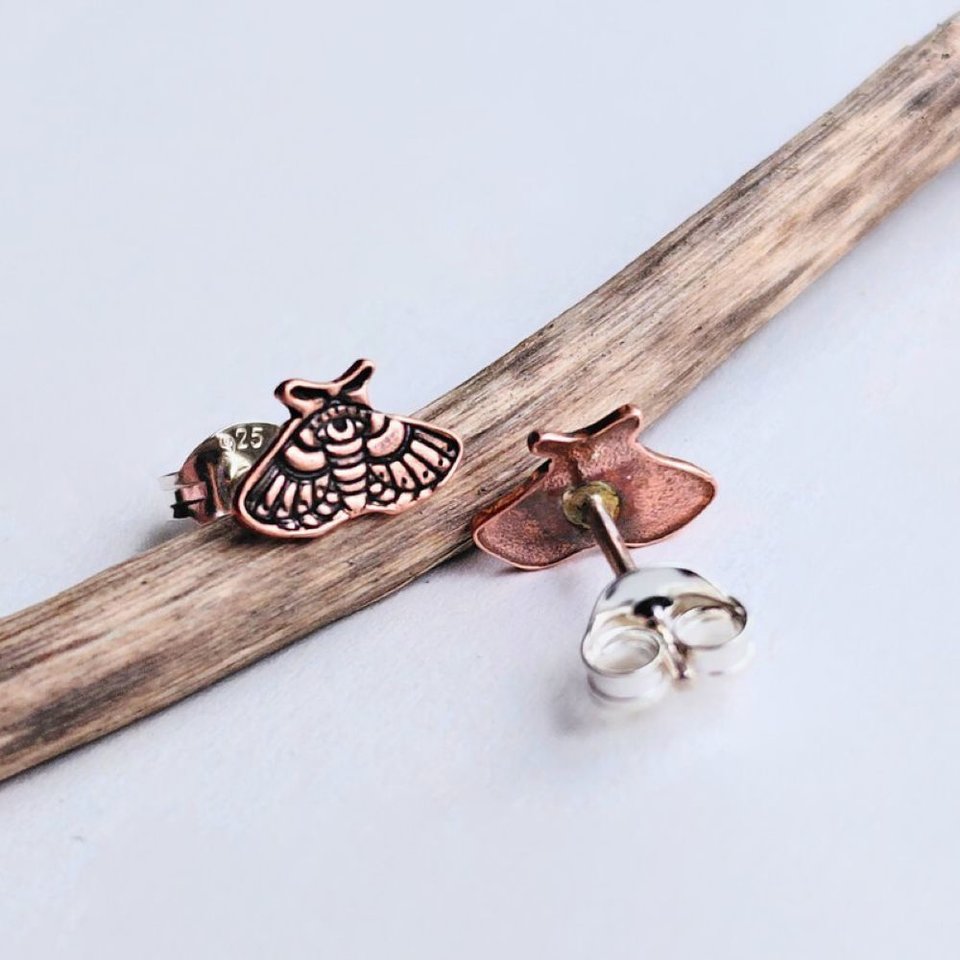 Copper moth stud earrings showing detailed moth design and sterling silver butterfly backs