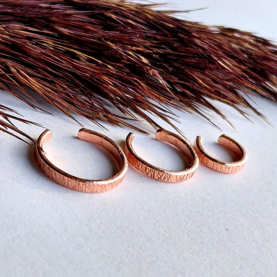 Three handcrafted copper ear cuffs with organic hammered texture in 7mm, 10mm and 12mm inner diameters
