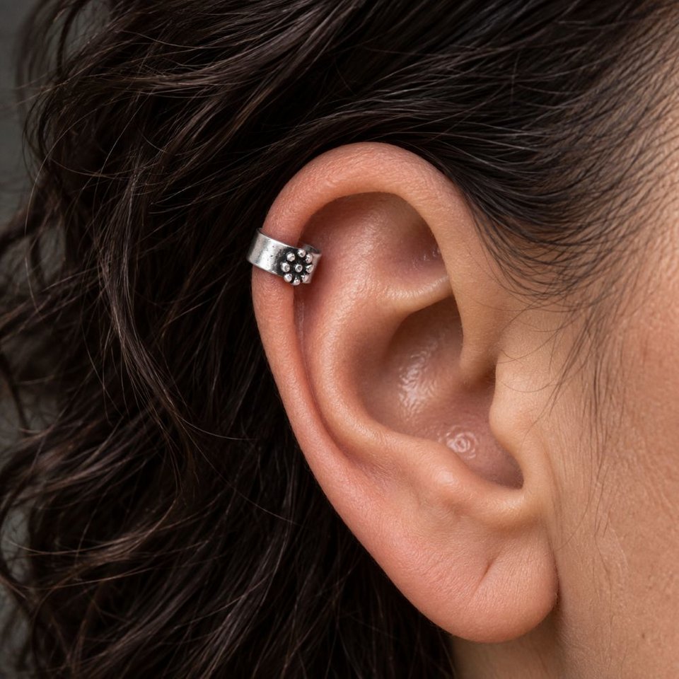 Fine silver daisy flower helix cuff worn on the upper ear/helix as a no-piercing alternative