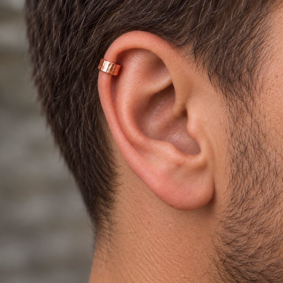 Hammered copper ear cuff shown being worn on the upper helix of a man's ear